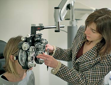 Emma testing a patient's eyes