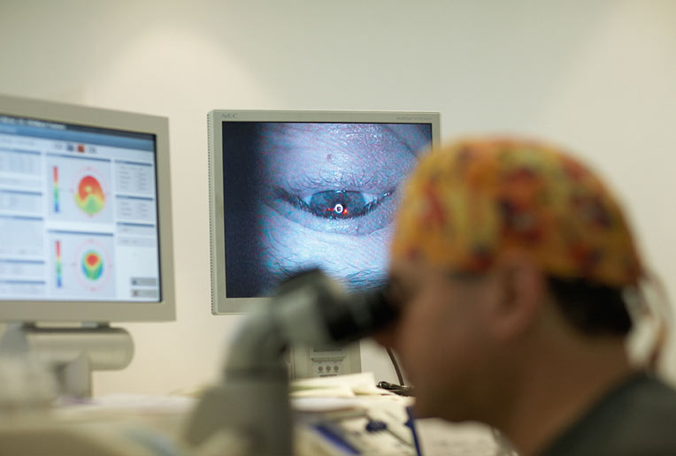 Professor Reinstein looks through microscope