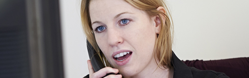 Laser Eye Surgery team member answering a call from a patient 